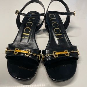 Sparingly used black Gucci sandals. Gold hardware.